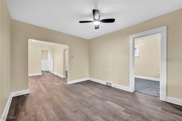 empty room featuring ceiling fan and wood-type flooring