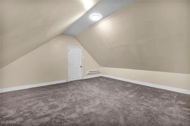 additional living space with carpet floors, vaulted ceiling, and a baseboard heating unit