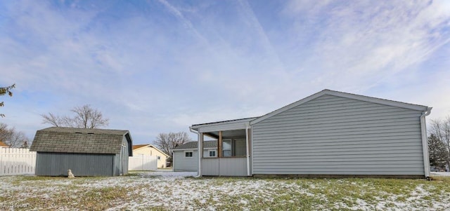 view of home's exterior with a storage shed