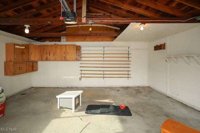 garage with wood ceiling and a garage door opener