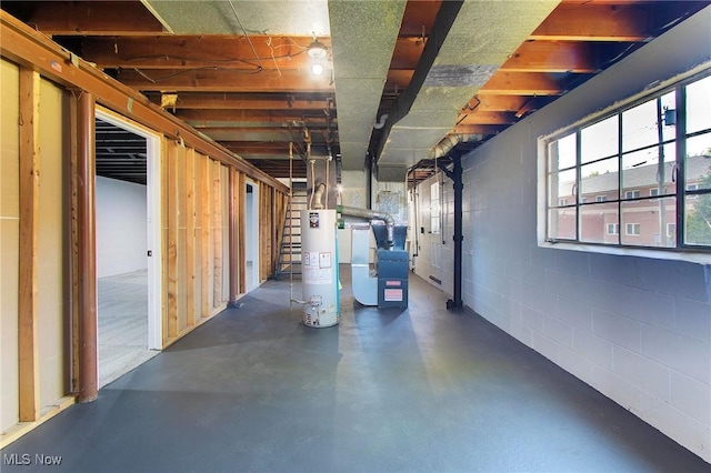 basement featuring gas water heater and heating unit