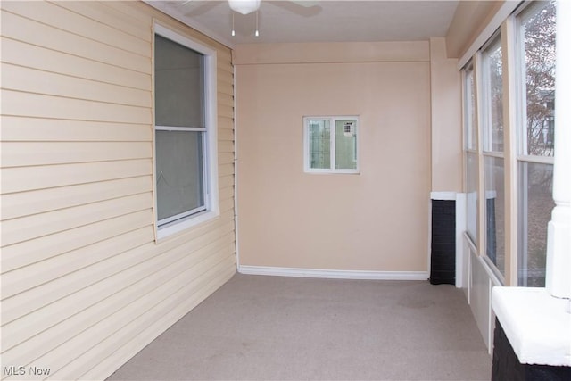 unfurnished sunroom featuring a wealth of natural light and ceiling fan