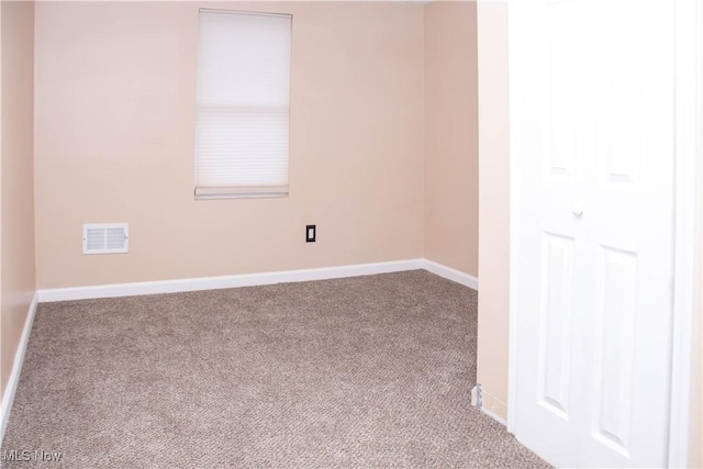 spare room featuring light colored carpet