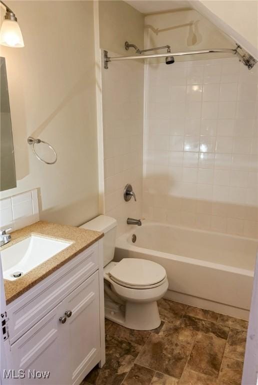 full bathroom featuring vanity, toilet, and tiled shower / bath