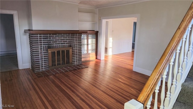 unfurnished living room featuring a tiled fireplace, hardwood / wood-style flooring, built in shelves, and a baseboard heating unit