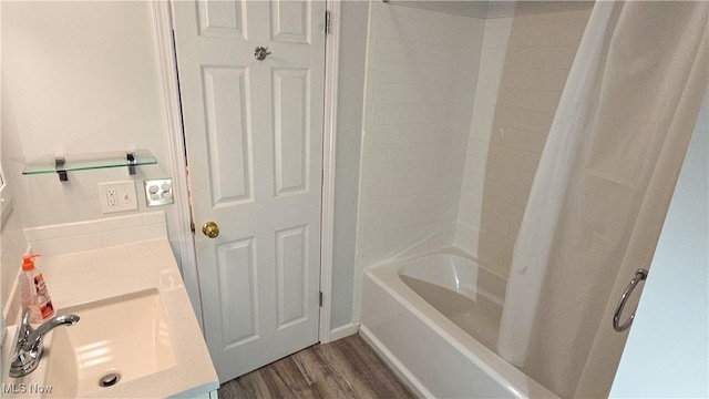 bathroom with sink, wood-type flooring, and  shower combination