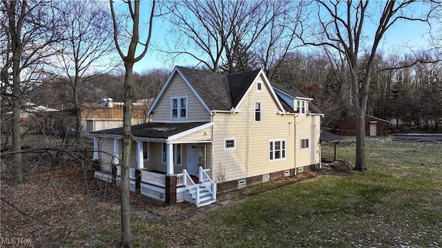 exterior space featuring a porch and a lawn