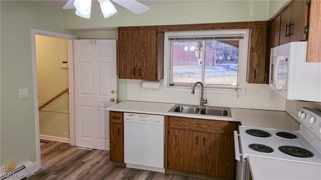 kitchen featuring white appliances, ceiling fan, baseboard heating, sink, and dark hardwood / wood-style floors