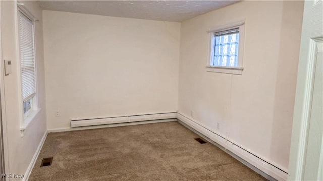 spare room with carpet flooring and a baseboard radiator