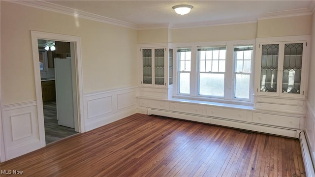 unfurnished room featuring ornamental molding, baseboard heating, and dark wood-type flooring