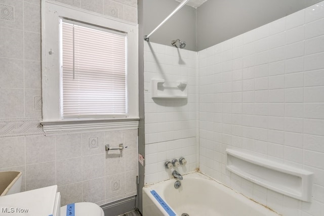 bathroom featuring toilet and shower / tub combination