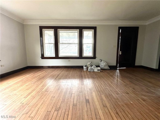 empty room with crown molding and hardwood / wood-style flooring