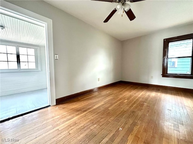 spare room featuring light hardwood / wood-style flooring, ceiling fan, and a healthy amount of sunlight