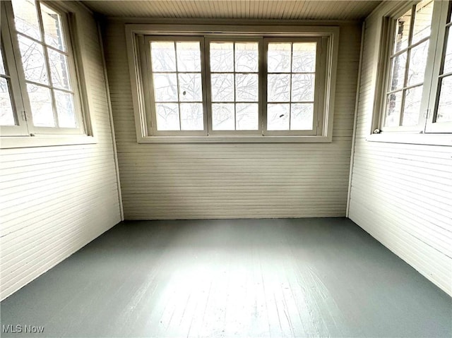 unfurnished sunroom with wood ceiling