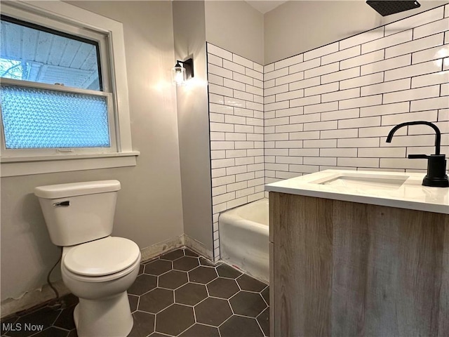 full bathroom featuring vanity, tiled shower / bath combo, and toilet