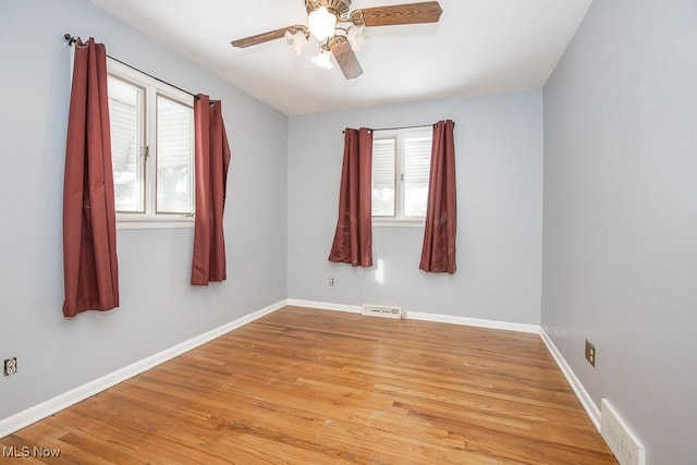 spare room featuring light hardwood / wood-style floors, plenty of natural light, and ceiling fan