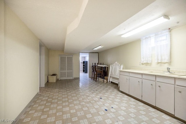 kitchen with white cabinetry and sink