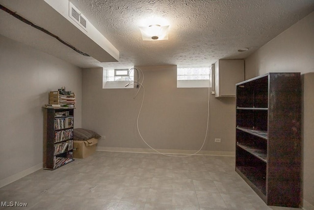 basement featuring a textured ceiling