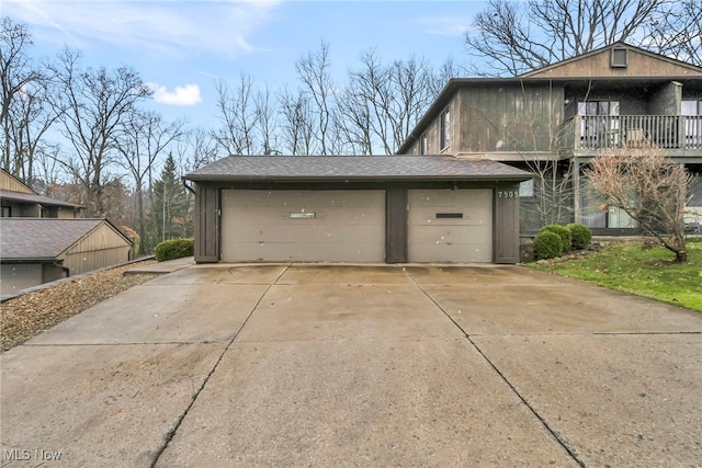 view of side of home featuring a balcony and a garage