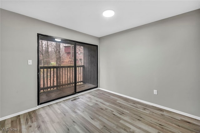 unfurnished room with light hardwood / wood-style floors