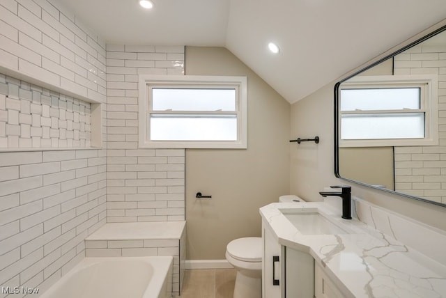 bathroom featuring wood-type flooring, lofted ceiling, toilet, a bathtub, and vanity