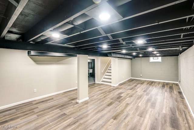 basement with hardwood / wood-style flooring