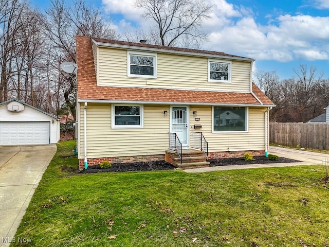 view of property featuring an outbuilding, a garage, and a front yard