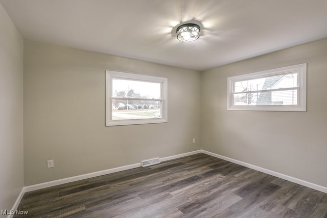 spare room with dark hardwood / wood-style flooring