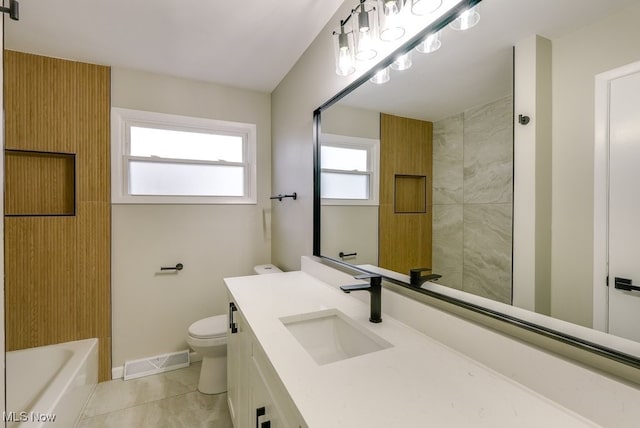 bathroom featuring tile patterned floors, vanity, and toilet