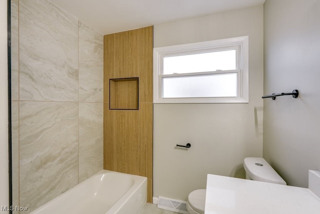 bathroom with shower / washtub combination and toilet