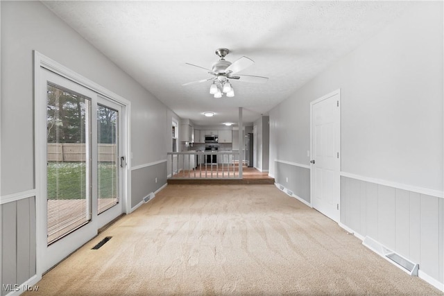 interior space featuring ceiling fan, a healthy amount of sunlight, and a textured ceiling