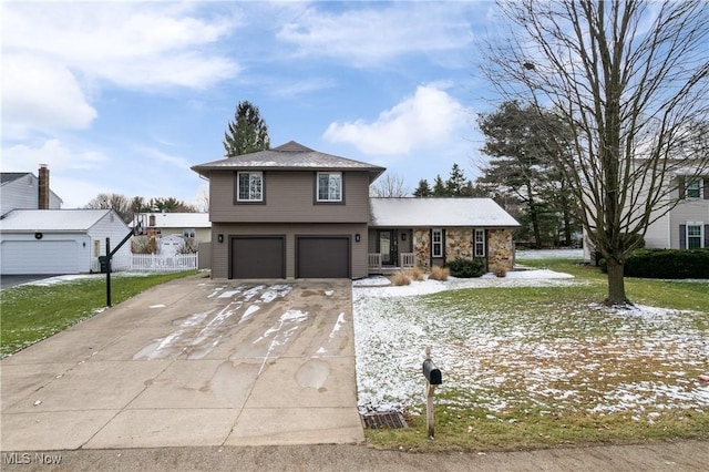 view of front of home featuring a garage and a front lawn