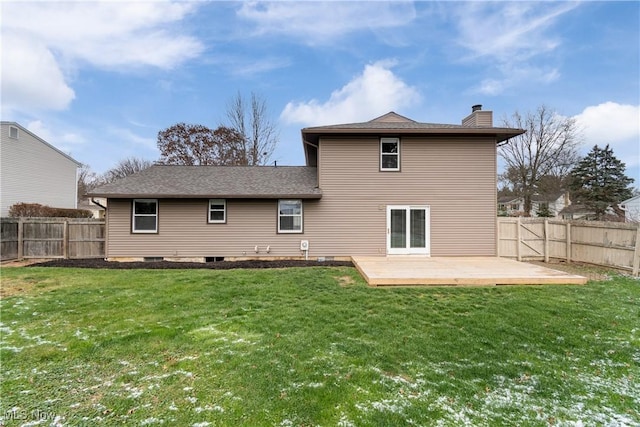 rear view of house with a lawn and a wooden deck