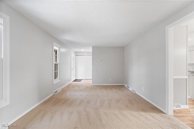 empty room featuring light carpet