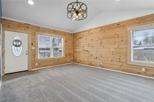 entryway with a healthy amount of sunlight and wood walls