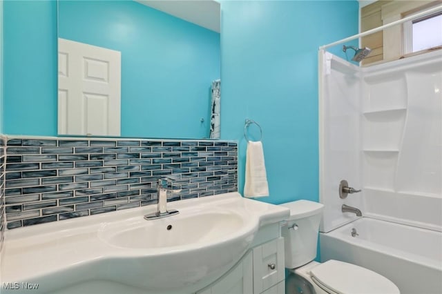 full bathroom featuring vanity, decorative backsplash, tub / shower combination, and toilet