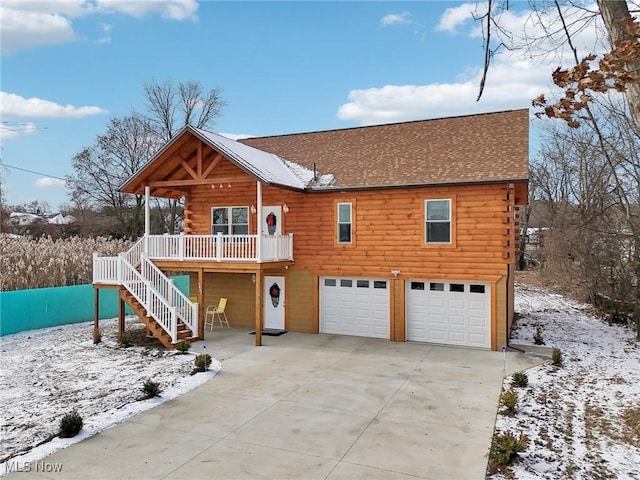 view of front of house featuring covered porch and a garage