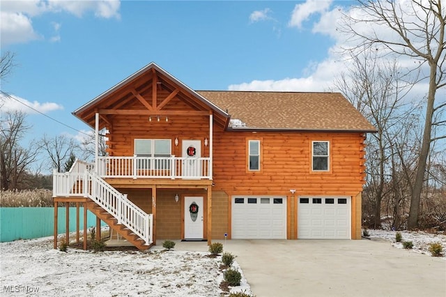 log-style house featuring a garage