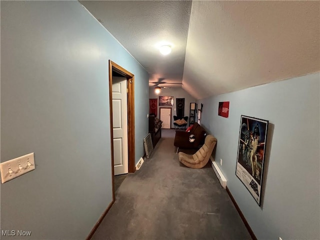 hallway with a textured ceiling, a baseboard radiator, dark carpet, and lofted ceiling