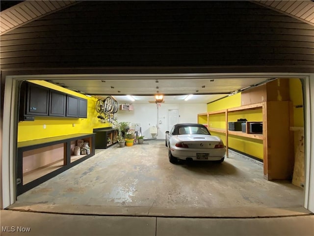 garage featuring an AC wall unit