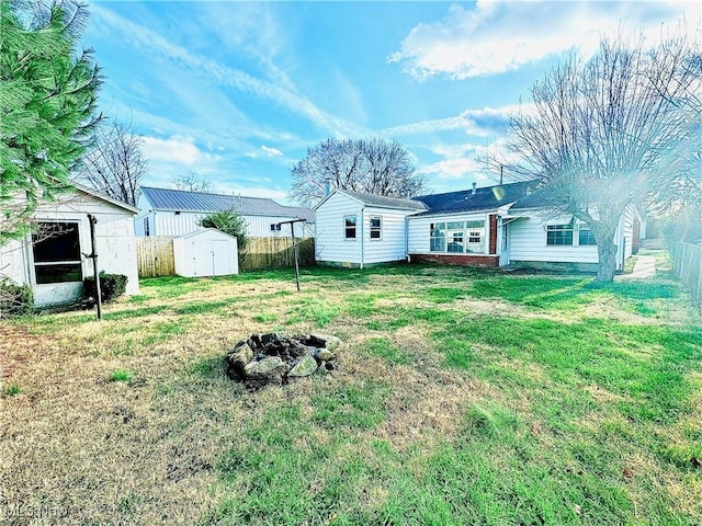 view of yard with a fire pit and a shed