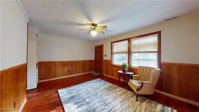 sitting room featuring dark hardwood / wood-style flooring and ceiling fan