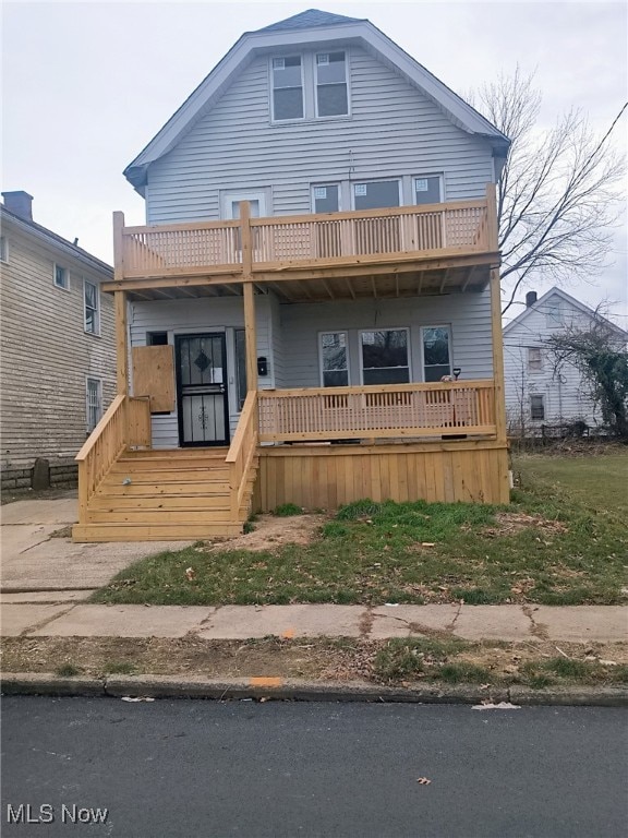 view of front of house with a porch and a balcony