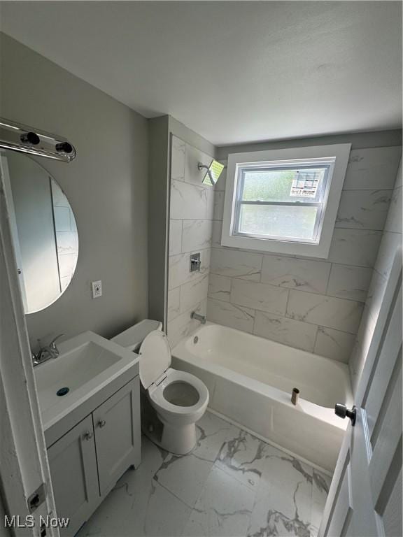 full bathroom with vanity, toilet, and tiled shower / bath