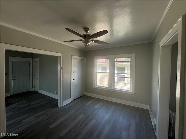 unfurnished bedroom with ceiling fan, dark hardwood / wood-style flooring, and ornamental molding