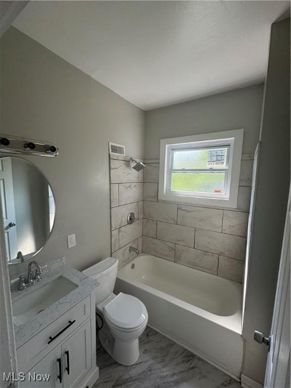 full bathroom with tiled shower / bath combo, toilet, and vanity