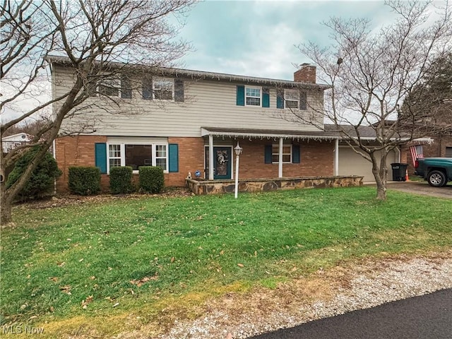 view of front of home with a garage and a front lawn