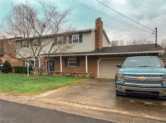 view of front of home with a front yard and a garage