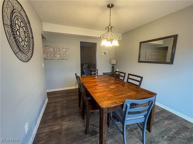 dining room featuring a chandelier and dark wood-type flooring