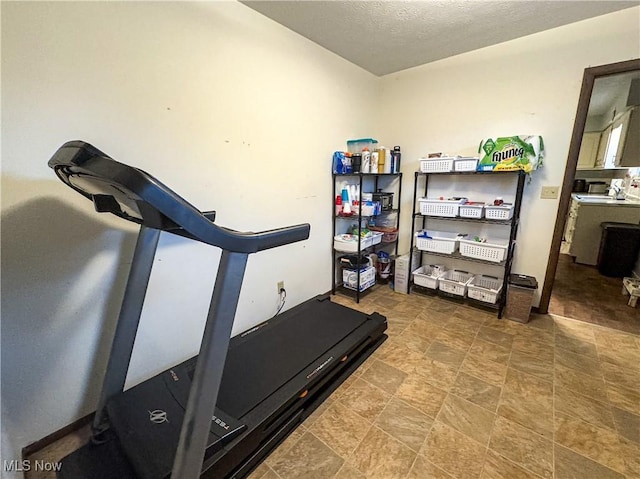 exercise room with a textured ceiling